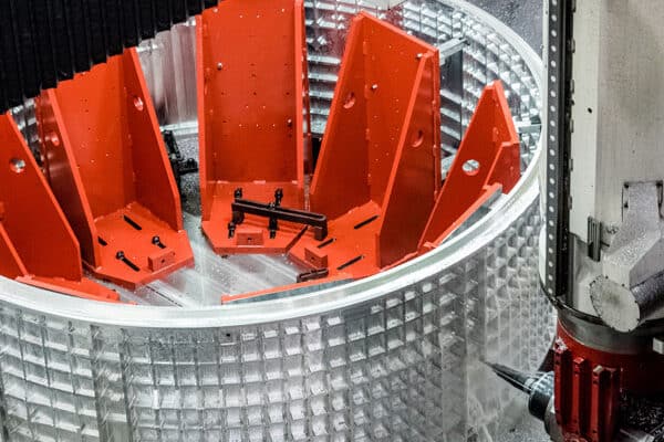 A large 5-axis CNC machine machining a metal part