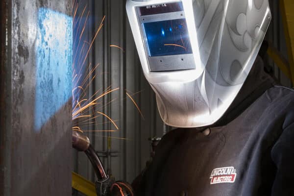 A fabricator welds a large metal component for the energy and power generation industry