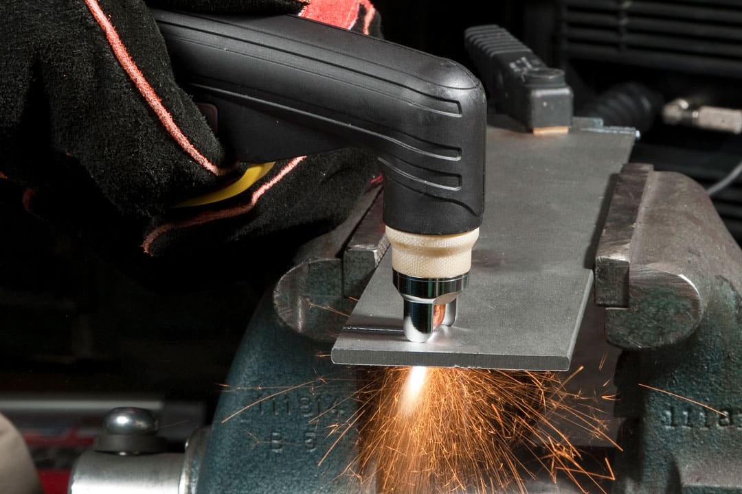 A manual plasma cutter cutting a component for large tooling or parts for the energy and power generation industry