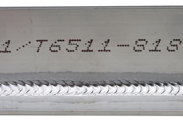 Weld beads (stacked dimes) on a metal part for the heavy equipment industry