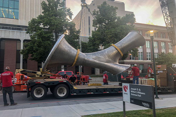 A large 3D-printed stainless steel sculpture (Convergence by Jenny Sabin Studio) being installed on-site