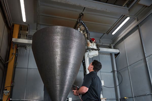 A large metal part inside a robotic large-scale 3D metal printing cell