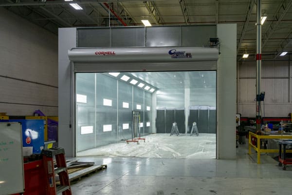 A large industrial spray booth for painting and coating large aerospace and space industry tooling, machined parts, weldments, and flight hardware